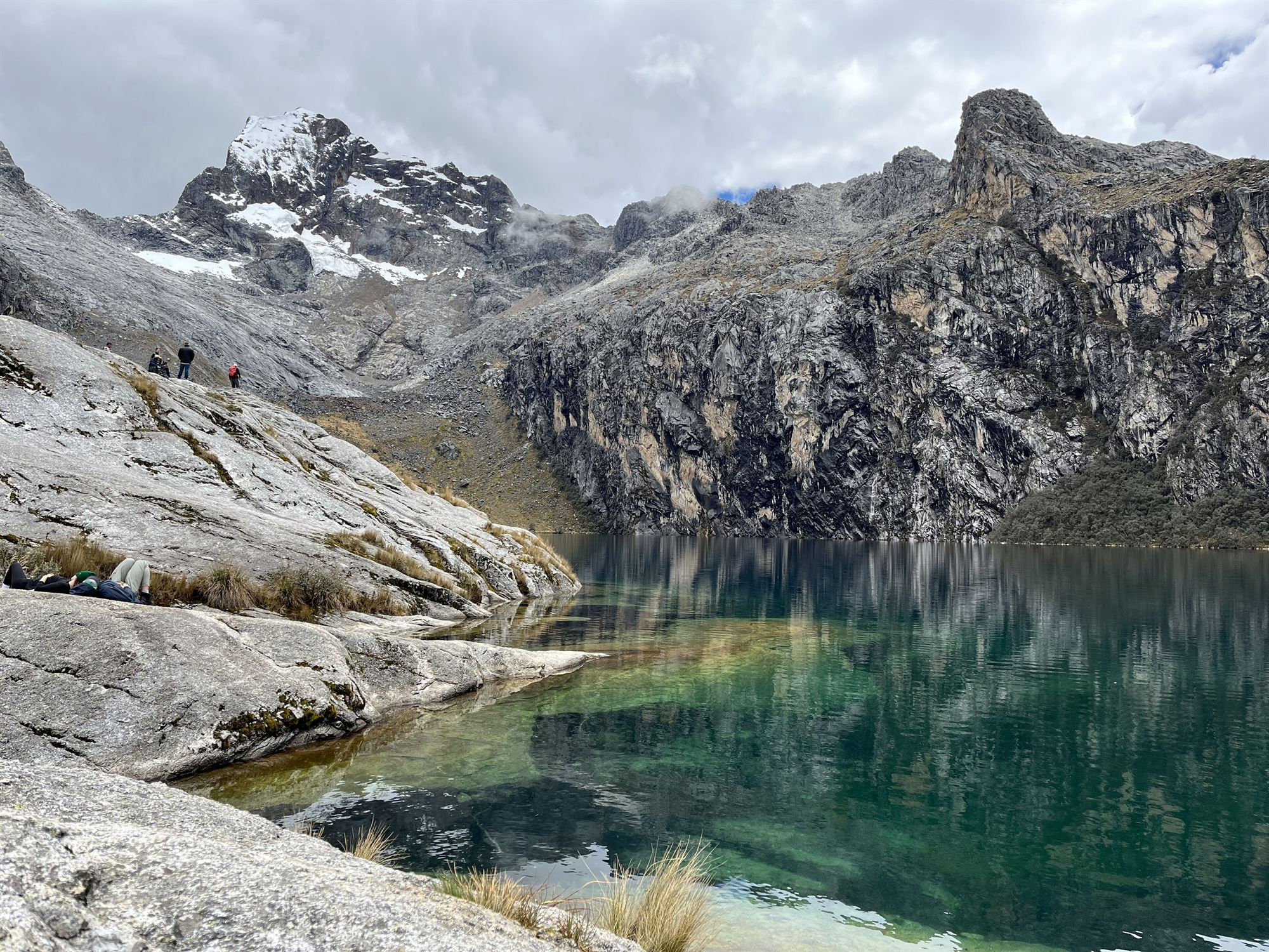 Viajeros en la orilla de la laguna Churup